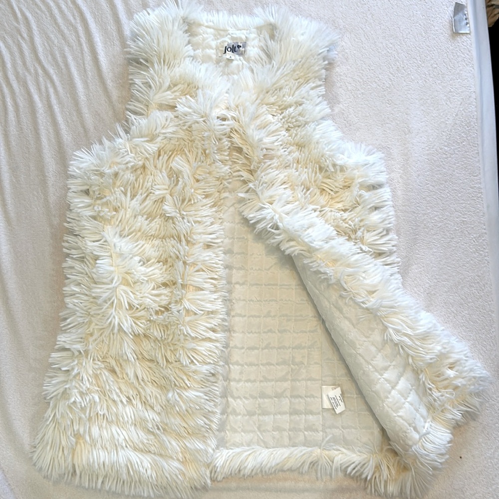 Fluffy white vest.